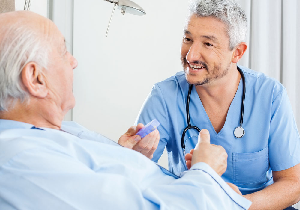 Physician Giving Older Man his Medications in Medical Facility
