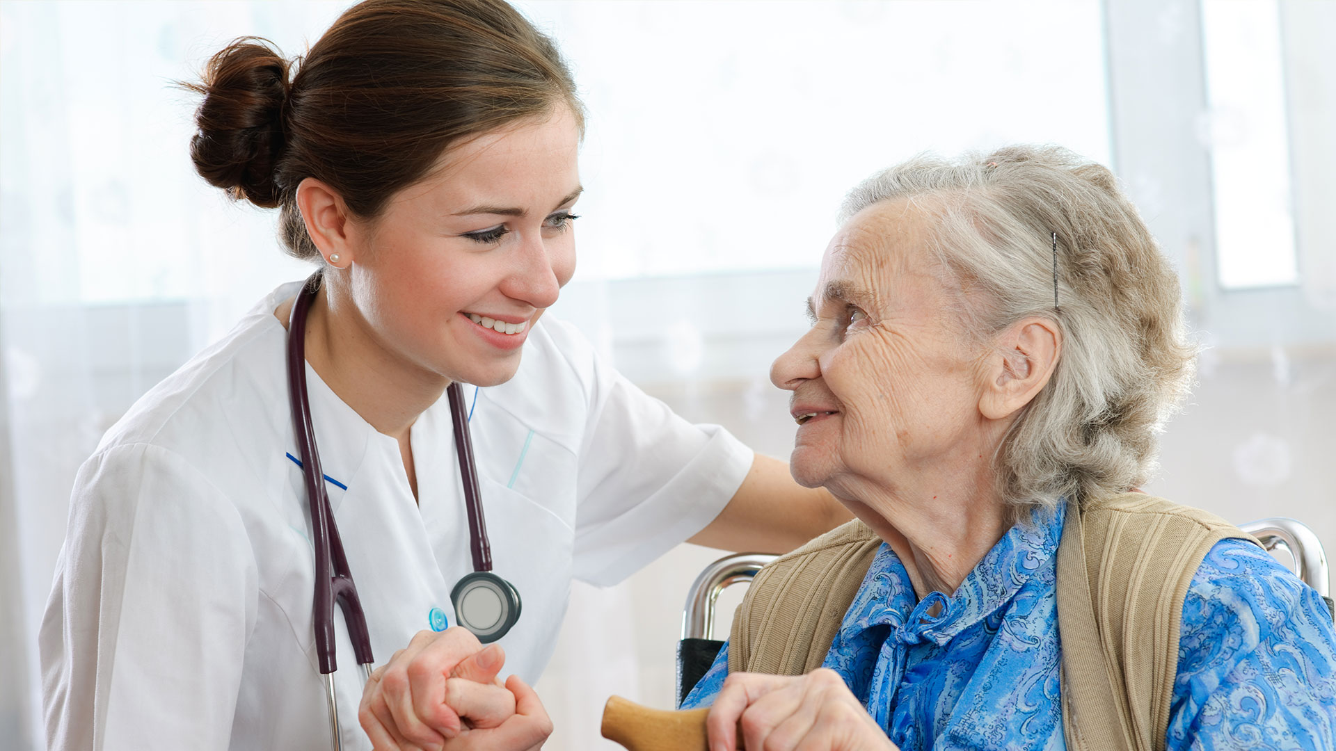 Physician Helping Older Woman and Smiling